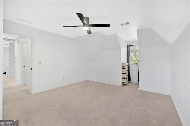 bonus room featuring light carpet, visible vents, baseboards, lofted ceiling, and ceiling fan