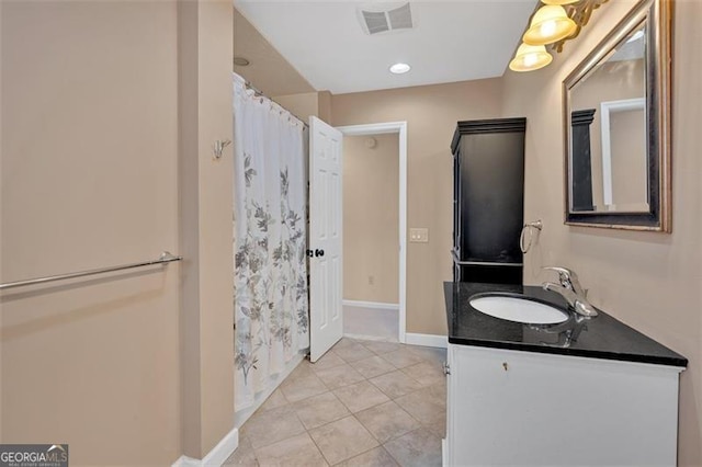 bathroom featuring curtained shower, visible vents, vanity, tile patterned flooring, and baseboards