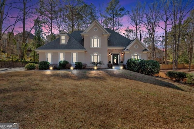 view of front of house featuring a front yard and stucco siding