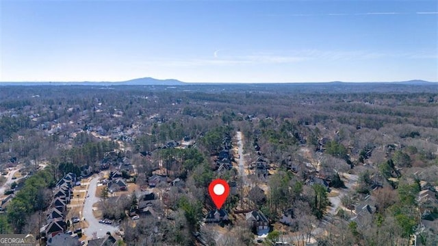 birds eye view of property with a mountain view and a view of trees