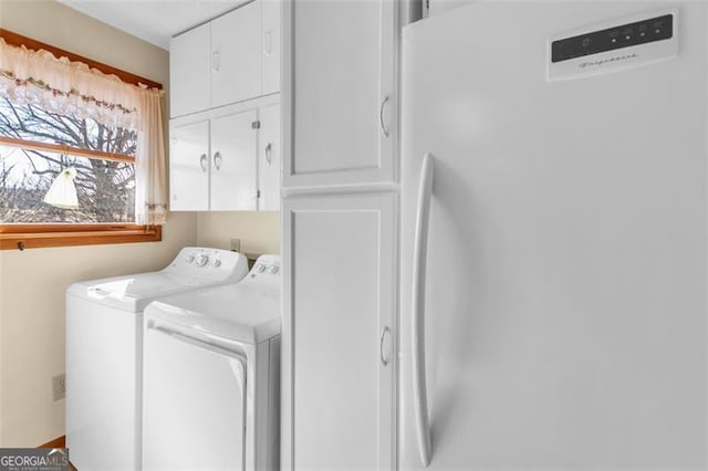 laundry room featuring cabinet space and washing machine and dryer