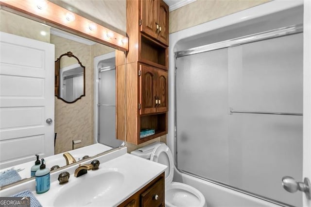 full bathroom featuring toilet, bath / shower combo with glass door, and vanity