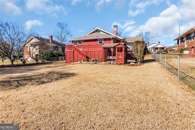 rear view of house with a yard, stairway, a fenced backyard, and a wooden deck