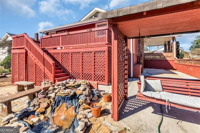 exterior space featuring a carport, a patio area, and stairs