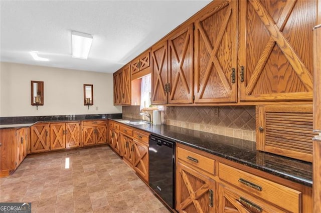 kitchen with brown cabinetry, black dishwasher, a sink, and decorative backsplash