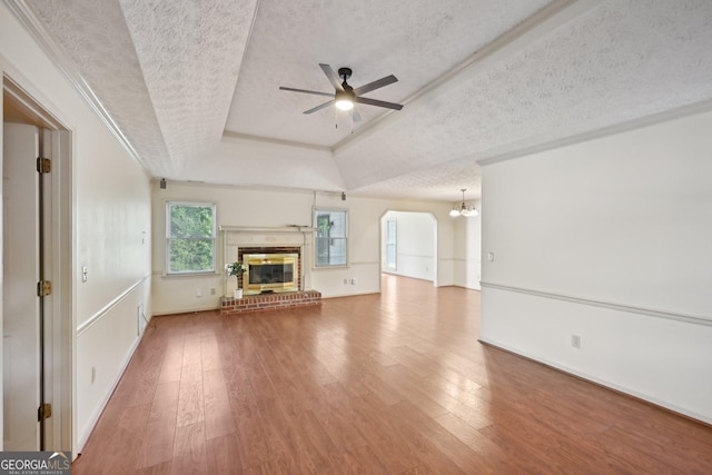2768 Southpark Blvd SW, Conyers, GA 30094 - unfurnished living room with a textured ceiling, a tray ceiling, ceiling fan, wood finished floors, and a chandelier