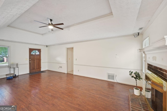 2768 Southpark Blvd SW, Conyers, GA 30094 - unfurnished living room featuring a fireplace, a textured ceiling, a raised ceiling, ceiling fan, and healthy amount of natural light