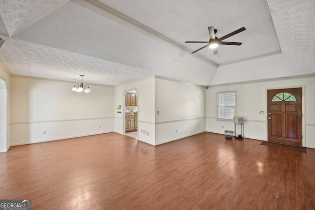 2768 Southpark Blvd SW, Conyers, GA 30094 - unfurnished living room with a textured ceiling, a chandelier, a ceiling fan, wood finished floors, and a tray ceiling