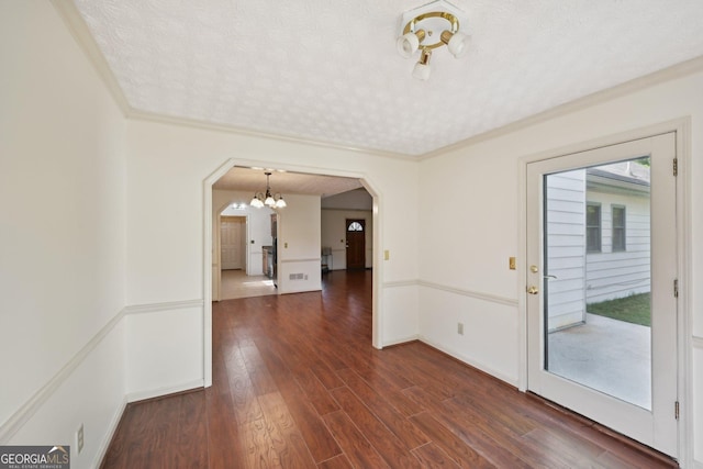 2768 Southpark Blvd SW, Conyers, GA 30094 - unfurnished room featuring arched walkways, a chandelier, dark wood-style flooring, and crown molding