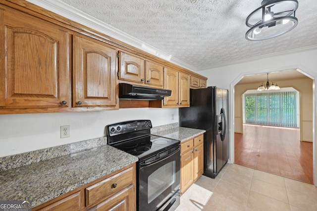 2768 Southpark Blvd SW, Conyers, GA 30094 - kitchen with black appliances, under cabinet range hood, a chandelier, arched walkways, and light tile patterned floors