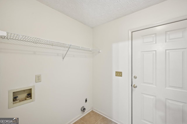 2768 Southpark Blvd SW, Conyers, GA 30094 - clothes washing area with washer hookup, light tile patterned floors, baseboards, a textured ceiling, and electric dryer hookup