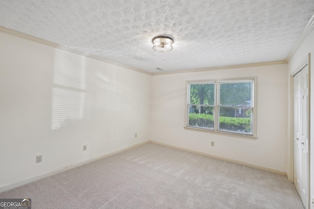 2768 Southpark Blvd SW, Conyers, GA 30094 - unfurnished bedroom featuring crown molding, light carpet, a textured ceiling, baseboards, and a closet