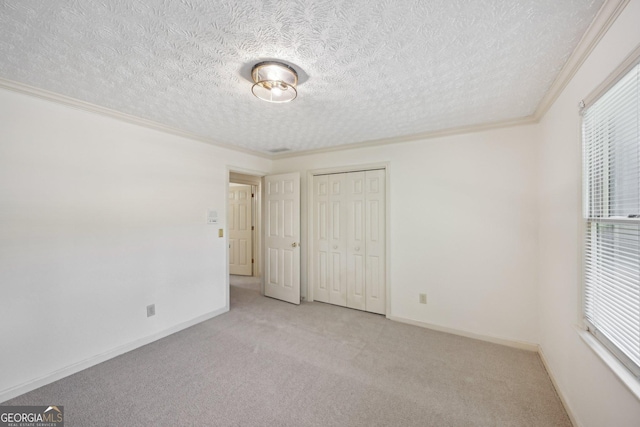 2768 Southpark Blvd SW, Conyers, GA 30094 - unfurnished bedroom featuring carpet, a textured ceiling, crown molding, a closet, and baseboards