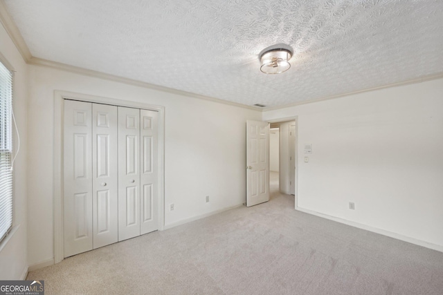 2768 Southpark Blvd SW, Conyers, GA 30094 - unfurnished bedroom with carpet floors, ornamental molding, a closet, baseboards, and a textured ceiling