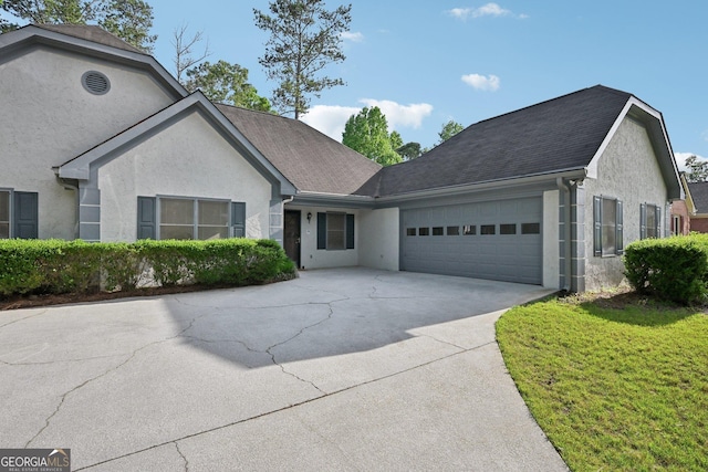 2768 Southpark Blvd SW, Conyers, GA 30094 - view of front of home featuring stucco siding, an attached garage, and driveway