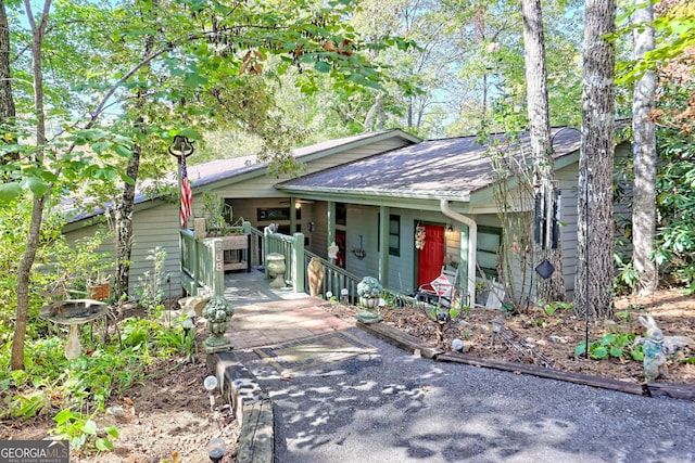 view of front of house with covered porch and roof with shingles