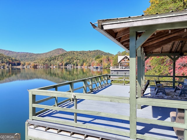 dock area with a forest view and a water and mountain view