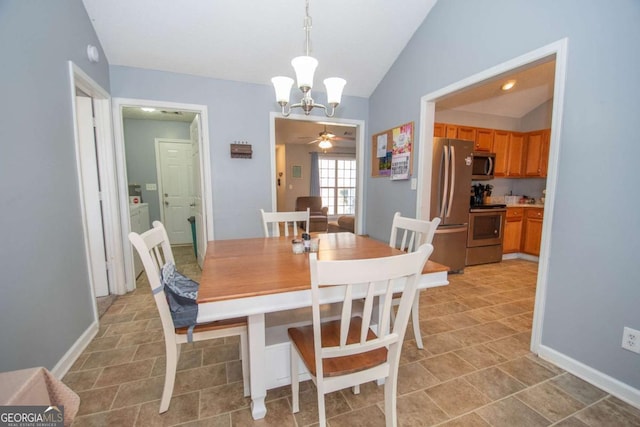 dining room with lofted ceiling, baseboards, and ceiling fan with notable chandelier