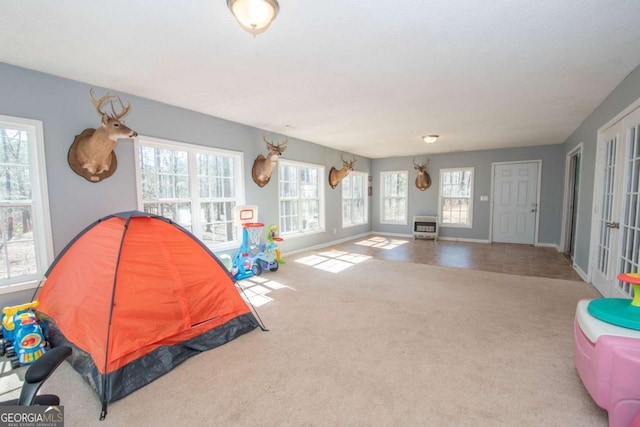 rec room featuring carpet floors and baseboards