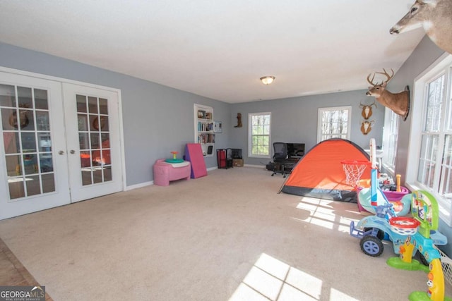 playroom featuring french doors, carpet, and baseboards