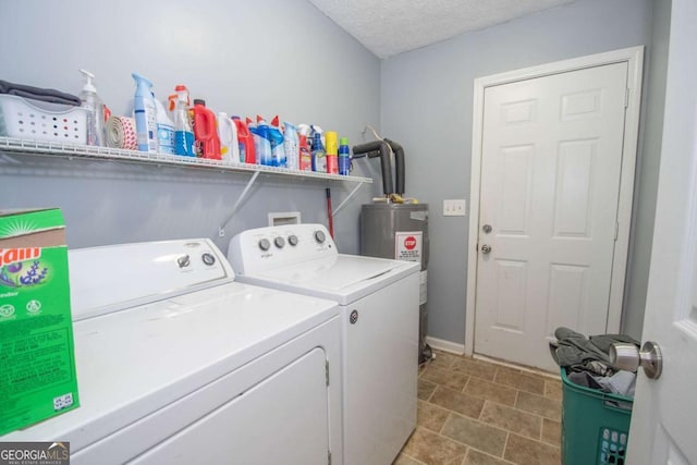 washroom with laundry area, washer and clothes dryer, a textured ceiling, and electric water heater