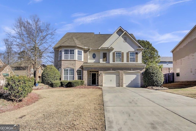 traditional home featuring driveway, a garage, and brick siding