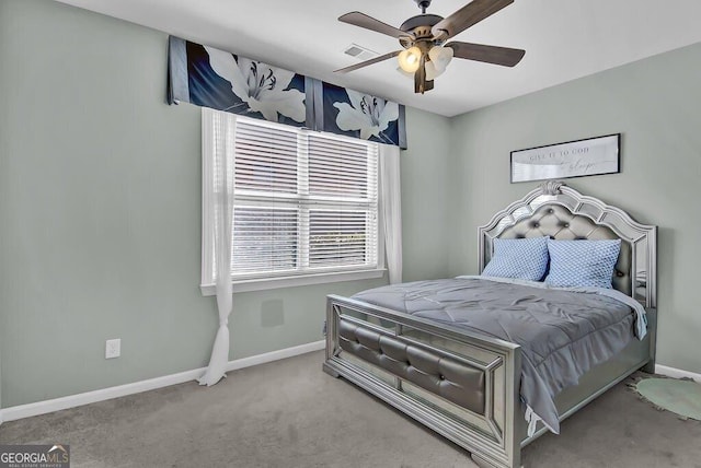 carpeted bedroom featuring ceiling fan, visible vents, and baseboards