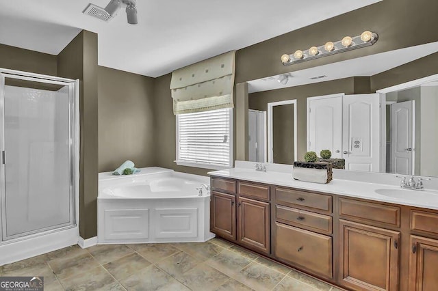 full bath featuring double vanity, a stall shower, visible vents, a garden tub, and a sink