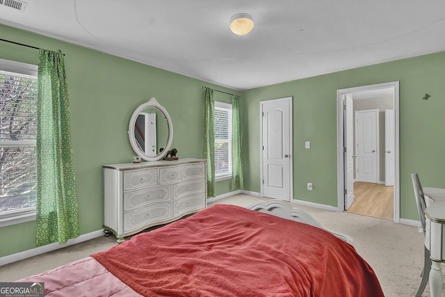 carpeted bedroom featuring visible vents and baseboards