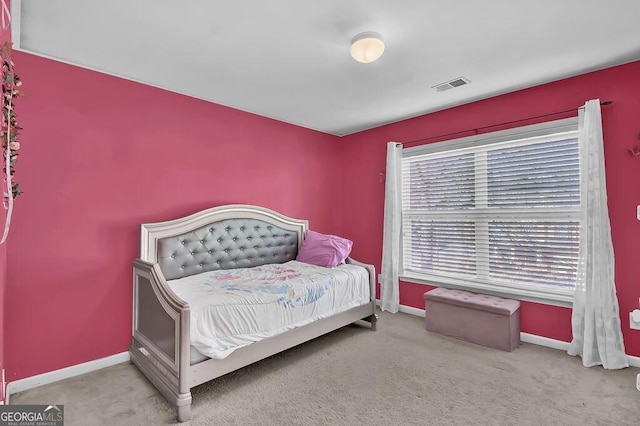 carpeted bedroom with visible vents and baseboards