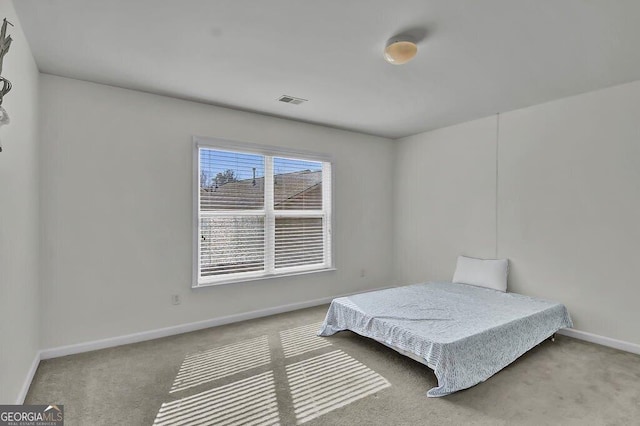 bedroom featuring carpet, visible vents, and baseboards