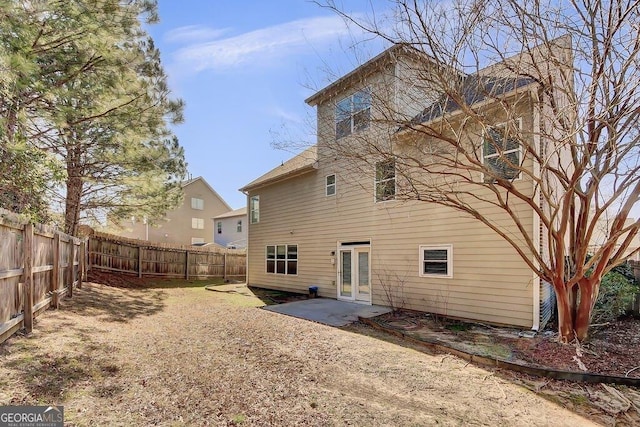 rear view of property featuring a fenced backyard