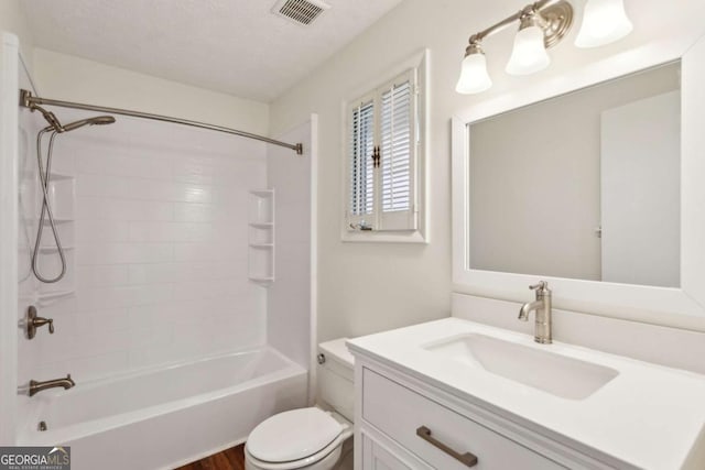 full bathroom featuring bathtub / shower combination, visible vents, toilet, vanity, and a textured ceiling