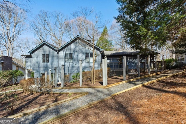 view of home's exterior with fence