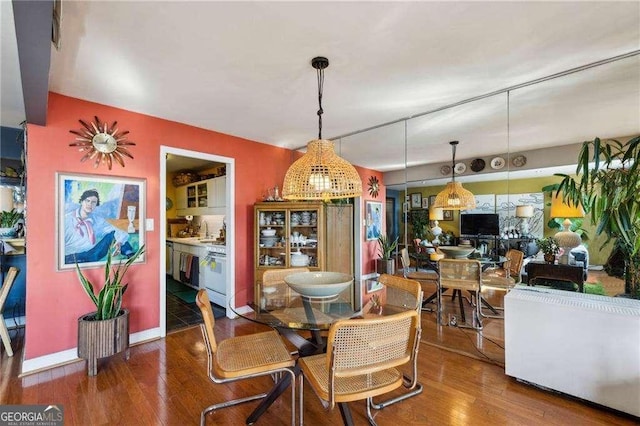 dining room with baseboards and wood finished floors