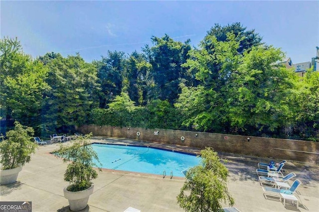 pool featuring a patio area and fence