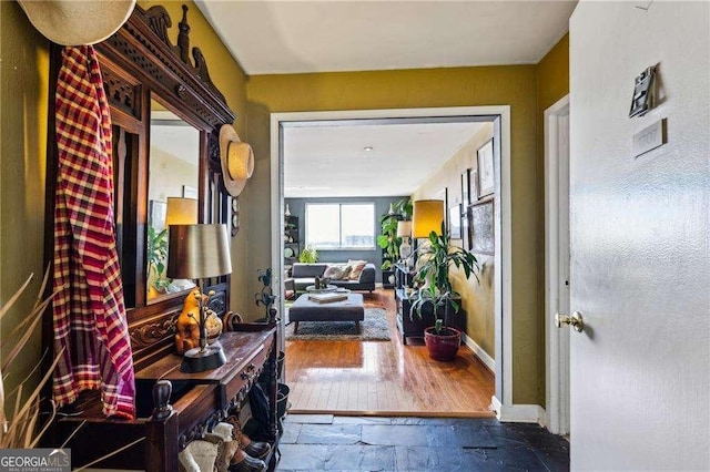 interior space with stone tile flooring and baseboards