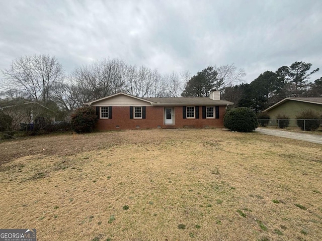 single story home with brick siding, a chimney, crawl space, fence, and a front lawn