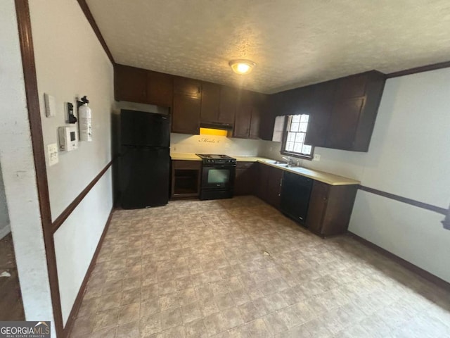 kitchen featuring a textured ceiling, under cabinet range hood, dark brown cabinets, light countertops, and black appliances