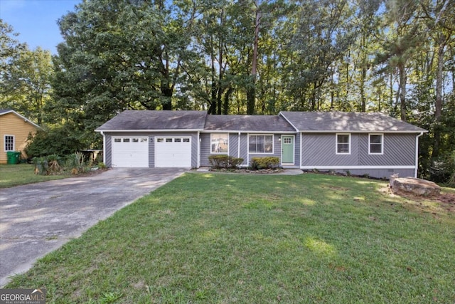 ranch-style house featuring an attached garage, driveway, and a front yard