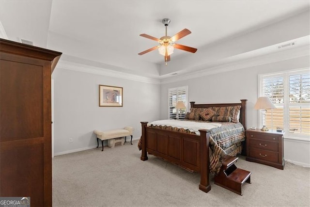 bedroom with ornamental molding, a raised ceiling, multiple windows, and light carpet