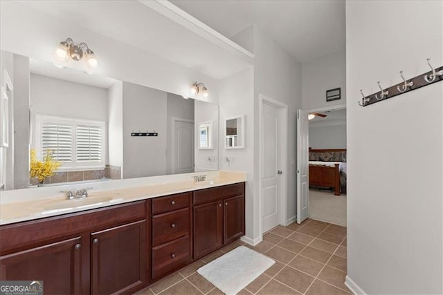 ensuite bathroom featuring double vanity, ensuite bath, tile patterned flooring, and a sink