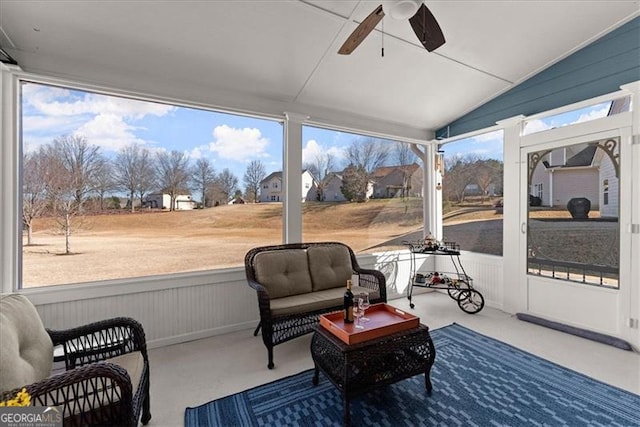 sunroom / solarium featuring lofted ceiling and ceiling fan