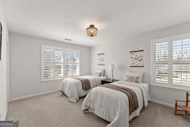 carpeted bedroom with baseboards, multiple windows, and visible vents