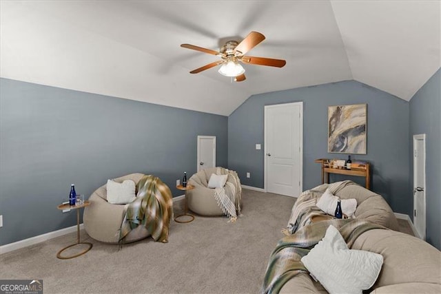 interior space with a ceiling fan, lofted ceiling, and baseboards