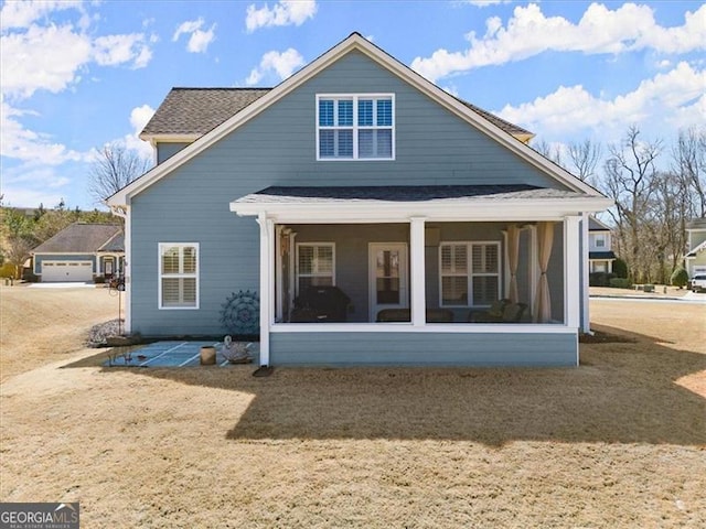 rear view of property featuring a sunroom