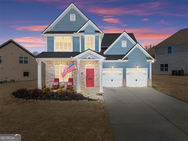 view of front of property with a porch, a front yard, cooling unit, and driveway