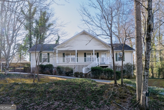 view of front facade featuring covered porch and stairway