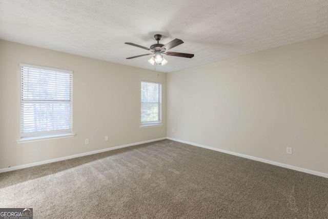 empty room featuring carpet floors, a textured ceiling, baseboards, and a ceiling fan