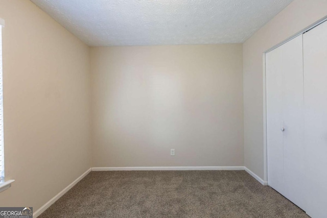 interior space featuring baseboards and a textured ceiling